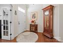 Elegant entryway with hardwood floors, large grandfather clock, and decorative accents at 10439 Donahue Dr, Huntersville, NC 28078