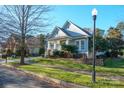 House exterior showcasing a front porch and manicured lawn at 10439 Donahue Dr, Huntersville, NC 28078