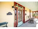 Charming front door with glass panels and rocking chairs on porch at 106 N Battleground Ave, Kings Mountain, NC 28086