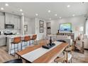 Open concept dining area with a live-edge wood table and seating for six at 115 Obadiah Ct, Mooresville, NC 28115