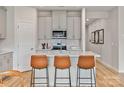 Island kitchen with light gray cabinets and quartz countertops at 115 Obadiah Ct, Troutman, NC 28115