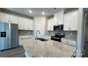 Spacious kitchen with white cabinets, granite countertops, and stainless steel appliances at 115 Obadiah Ct, Troutman, NC 28115