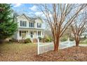 Two-story house with light-yellow siding, shutters, and a white picket fence at 119 Heritage Creek Dr, Hickory, NC 28601