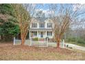 Two-story house with light yellow siding, white columns, and a white picket fence at 119 Heritage Creek Dr, Hickory, NC 28601