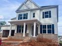 Charming two-story home with white siding, black shutters, and a welcoming covered front porch at 13312 Chopin Ridge Rd, Huntersville, NC 28078