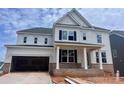 New construction, two-story home showcasing modern white siding and brick accents at 13312 Chopin Ridge Rd, Huntersville, NC 28078