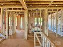 Unfinished interior framing for new home showcasing the layout, window locations, and natural light potential at 13312 Chopin Ridge Rd, Huntersville, NC 28078