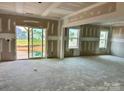 Unfinished living room with sliding glass doors to the backyard allowing ample natural light at 13312 Chopin Ridge Rd, Huntersville, NC 28078
