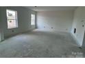 Large, empty room with natural light streaming through windows, ready to be customized at 13312 Chopin Ridge Rd, Huntersville, NC 28078