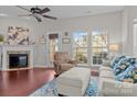 Cozy living room with fireplace, hardwood floors, and ample natural light at 13823 Waverton Ln, Huntersville, NC 28078