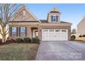 Two-story home with a two-car garage and manicured lawn at 145 Chertsey Dr, Mooresville, NC 28115