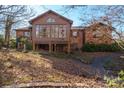 Back of house showcasing sunroom addition and landscaping at 2452 Nc 182 Hwy, Lincolnton, NC 28092