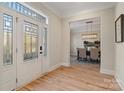 Hardwood floors, an open view to the dining room, and a glass door at 2717 Madison Oaks Ct, Charlotte, NC 28226