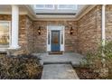 Inviting front entrance with stone facade and a blue door at 2717 Madison Oaks Ct, Charlotte, NC 28226