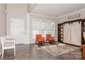 Living room with orange armchairs, a barn door cabinet, and wood floors at 4115 Stuart Ln, Indian Land, SC 29707