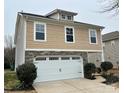 Two-story house, tan siding, white garage doors at 5121 Stone Park Dr, Charlotte, NC 28269