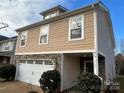 Tan two-story house with white two-car garage and landscaping at 5121 Stone Park Dr, Charlotte, NC 28269