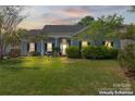 Charming single-story home with well-manicured lawn, complemented by beautiful landscaping and a welcoming entrance at 8523 Albury Walk Ln, Charlotte, NC 28277