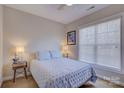 Cozy bedroom with light blue bedding and large window at 17627 Caddy Ct, Charlotte, NC 28278