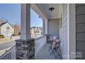 Inviting front porch with stone columns and white railing at 17627 Caddy Ct, Charlotte, NC 28278