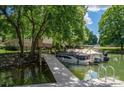 Picturesque waterfront view showcasing a wooden dock and serene, boat-filled waters at 1934 Hickory Hills Dr, Denver, NC 28037
