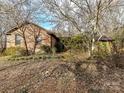 Brick ranch house with a covered porch, surrounded by trees at 10035 Little Creek Rd, Mint Hill, NC 28227