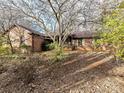 Brick ranch house with a covered porch and landscaping at 10035 Little Creek Rd, Mint Hill, NC 28227