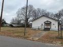 Quaint church exterior with ramp access, set on a lot with mature trees and overcast sky at 1319 7Th St, Statesville, NC 28677