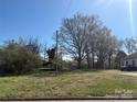 A vacant lot ready for development featuring lush trees and a bright, sunny sky at 1319 7Th St, Statesville, NC 28677