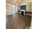 Living room with fireplace, built-in shelving, and hardwood floors at 14243 Richmond Park Ave, Charlotte, NC 28277