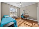 Cozy bedroom featuring a comfortable bed, hardwood floors, and a bright window at 18119 Coulter Pkwy, Cornelius, NC 28031