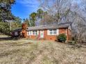 Classic brick home with white trimmed windows and a chimney on the left at 1830 Light Brigade Dr, Matthews, NC 28105