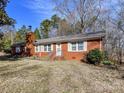 Classic brick home with white trimmed windows and a chimney on the left at 1830 Light Brigade Dr, Matthews, NC 28105