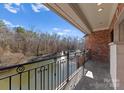 Brick balcony overlooking a tranquil lake and fountain at 2310 La Maison Dr, Charlotte, NC 28226