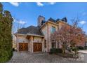 Two-car garage with unique wooden doors and a stone facade at 2310 La Maison Dr, Charlotte, NC 28226