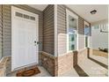 White front door with sidelights and a brick base at 414 Shallowford Dr # 44, Rock Hill, SC 29732