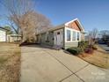 Updated home with a new driveway, landscaping, and gray siding at 535 Brooklyn Ave, Cramerton, NC 28032