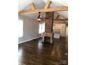 Spacious living area with exposed beams, brick fireplace, and hardwood floors at 535 Brooklyn Ave, Cramerton, NC 28032