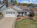 Gray craftsman style home with a metal roof and welcoming front porch at 7145 Hanging Rock Ct, Denver, NC 28037