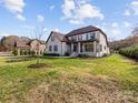 Two-story house with brick facade, brown roof, and landscaped yard at 719 Greenbriar Dr, Matthews, NC 28104