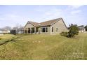 Rear view of house with covered patio and fenced backyard at 1132 Cades Ct, Denver, NC 28037
