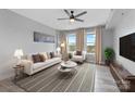 Bright living room featuring large windows, neutral decor, and comfortable seating arrangement at 1315 East Blvd # 433, Charlotte, NC 28203