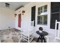 White front porch with rocking chairs and a red front door at 1511 S Wendover Rd, Charlotte, NC 28211