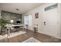 Bright home office with desk, shelving, and wood floors at 1844 Giana Ln, Monroe, NC 28112