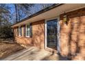 Brick front entrance with decorative glass door and traditional outdoor lighting at 206 Fox Den Rd, Troy, NC 27371
