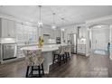 Modern kitchen with white cabinets, a large island, and stainless steel appliances at 5259 Sweet Fig Way, Fort Mill, SC 29715