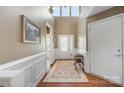 Charming foyer with a hardwood floor, beautiful rug, and natural light streaming through the door and transom windows at 5981 Bison Ct, Fort Mill, SC 29707
