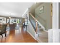 Spacious hallway featuring hardwood floors, stairs leading to the upper level, and an open view of the living area at 5981 Bison Ct, Fort Mill, SC 29707