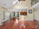 Open concept living room and dining area featuring hardwood floors, natural light, and easy kitchen access at 9903 Southampton Commons Dr, Charlotte, NC 28277