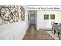 Elegant hallway with wood flooring, wainscoting, and stylish wall art at 1023 Canvasback Way, Indian Trail, NC 28079